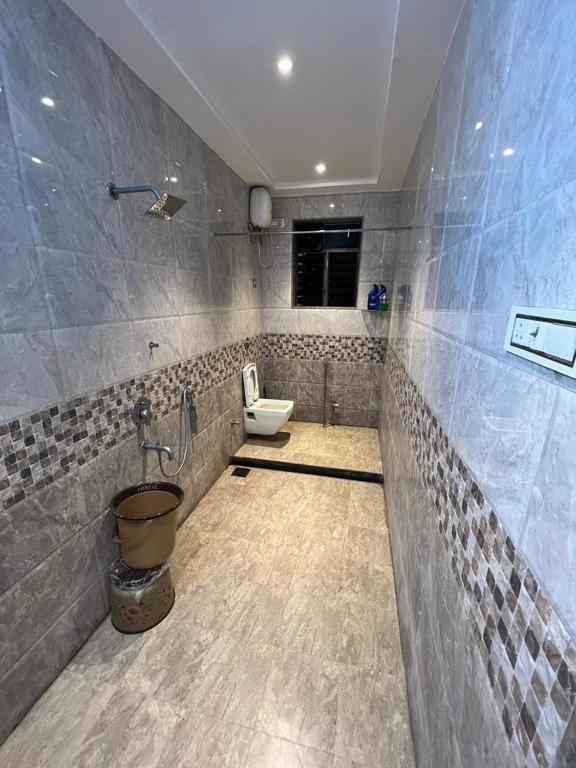 a bathroom with a toilet and a sink at Mountain Bliss Villa Gorai in Mumbai