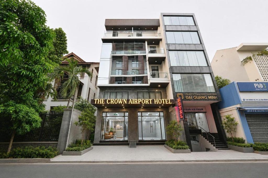 a building with a sign that reads the crown airport hotel at The Crown Airport Hotel in Ho Chi Minh City