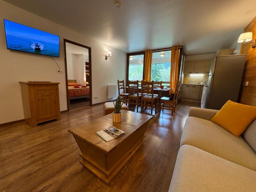 a living room with a couch and a table at Artemis 402 2 chambres et coin montagne in Brides-les-Bains