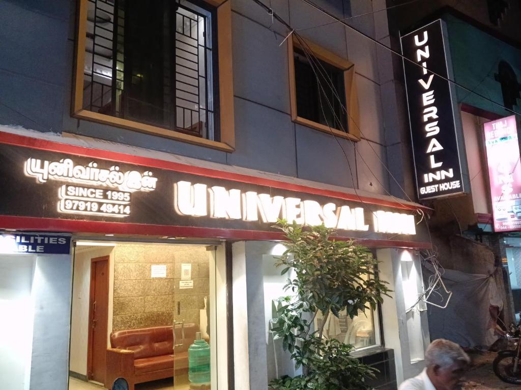 a sign for an entrance to a restaurant at Universal Inn in Chennai