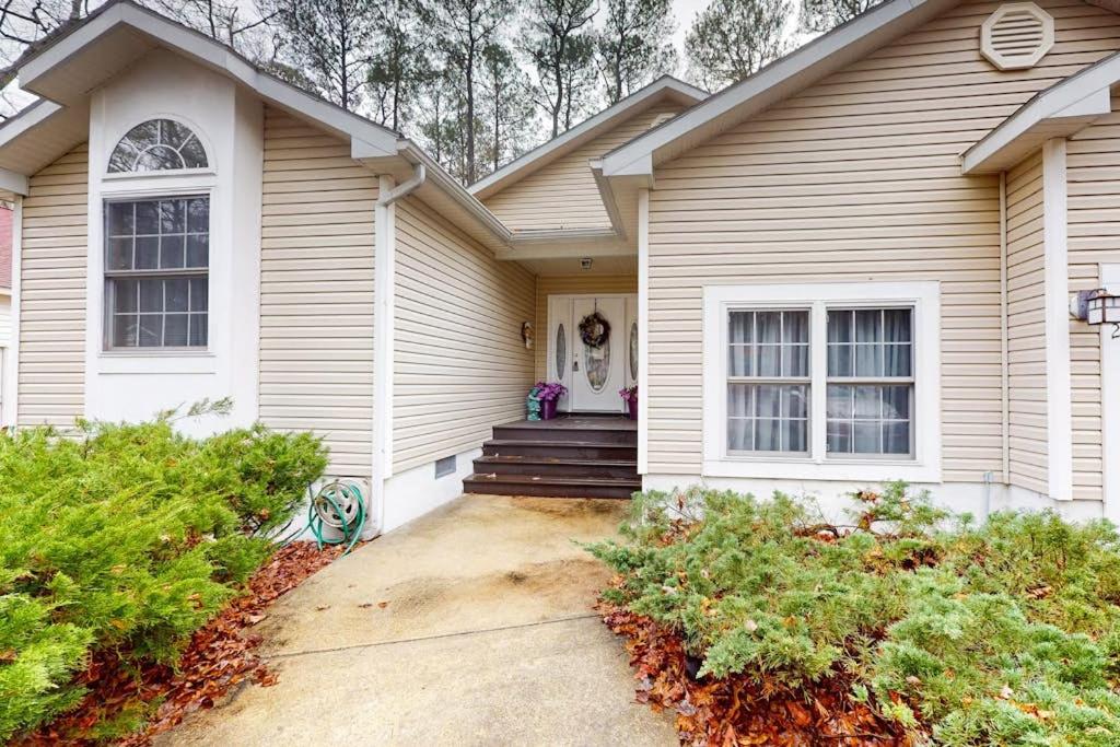 a white house with a porch and stairs to the door at 22 Harpoon rd in Ocean Pines