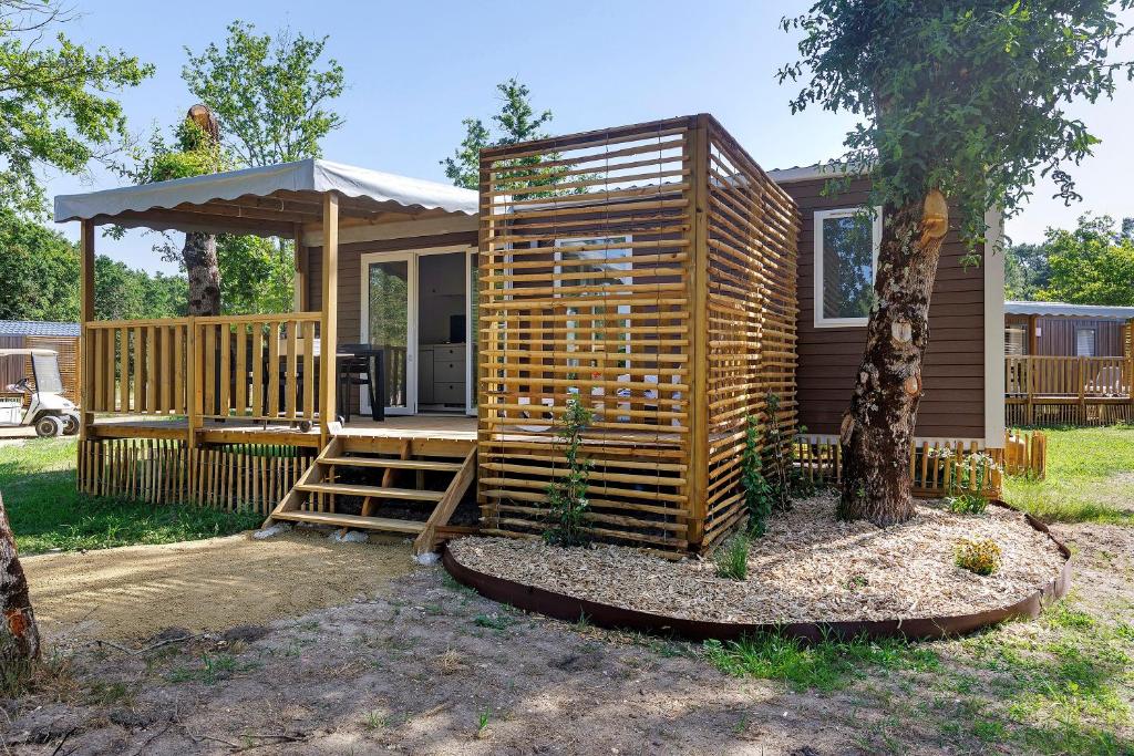 a tiny house with a porch and a gazebo at Mobilehome Vallon 49 in Saint-Gervais