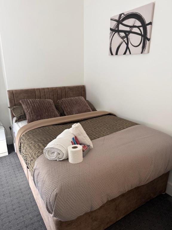 a bedroom with a bed with two towels on it at Premium Bedroom Escape in Hull