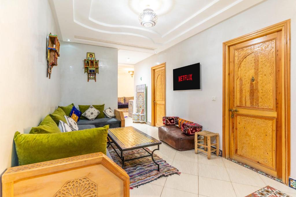 a living room with a couch and a table at Al manar in Oulad Akkou