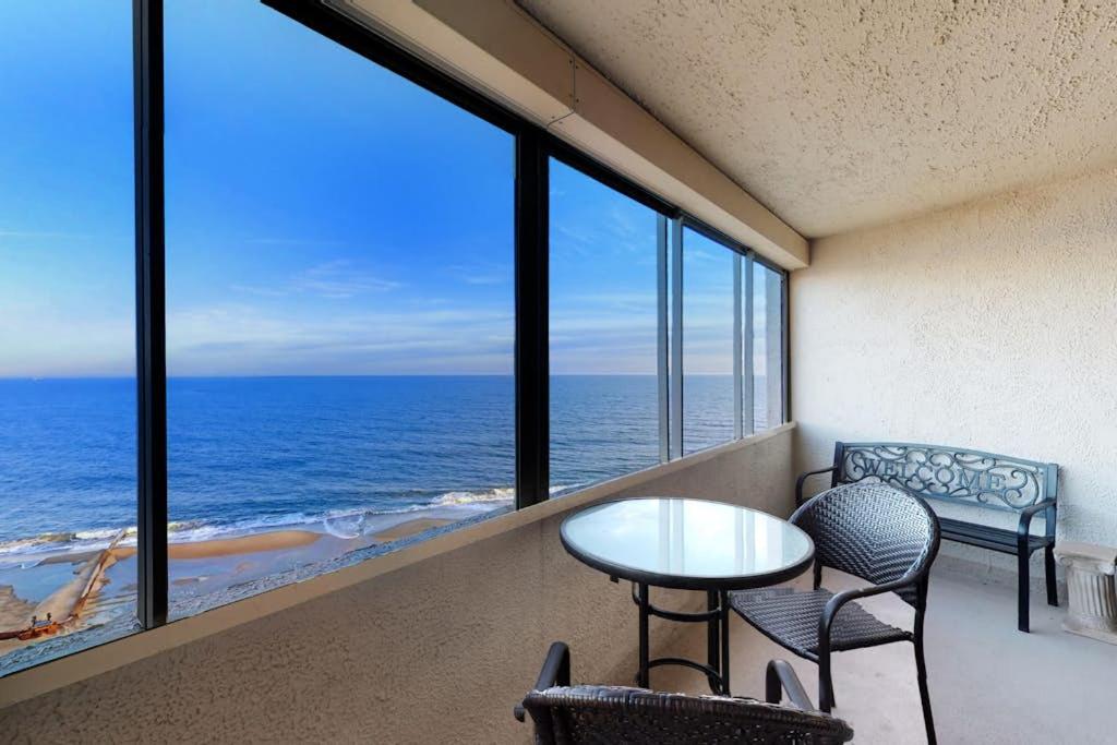 a room with a table and chairs and a view of the ocean at Antigua 1004 in Ocean City