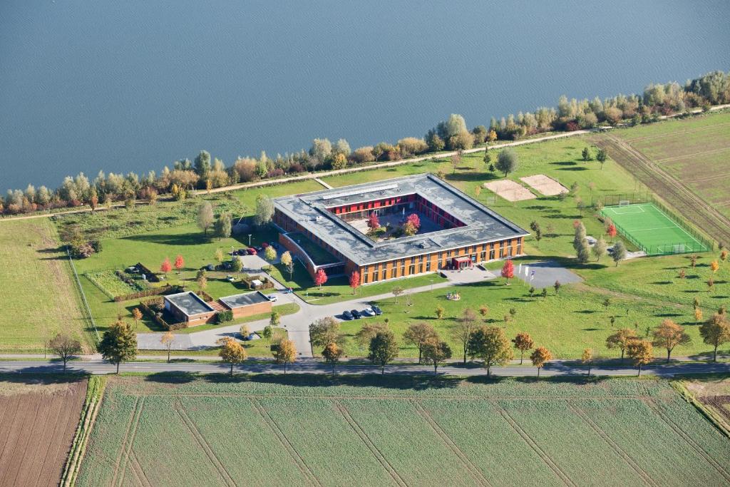 an aerial view of a building with a soccer field at DJH Jugendherberge Xanten in Xanten