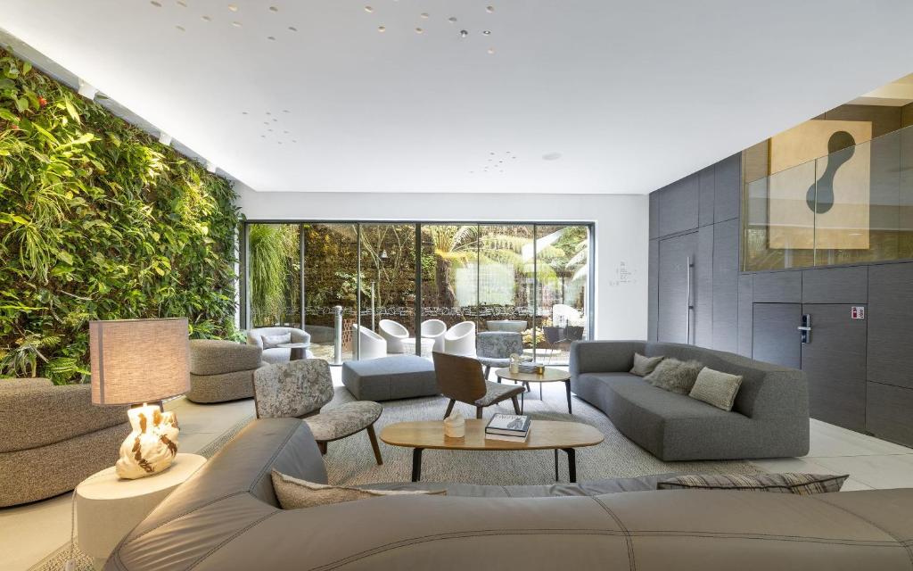 a living room with a couch and chairs and a table at BW Premier Collection Le Saint Antoine Hotel et Spa in Rennes