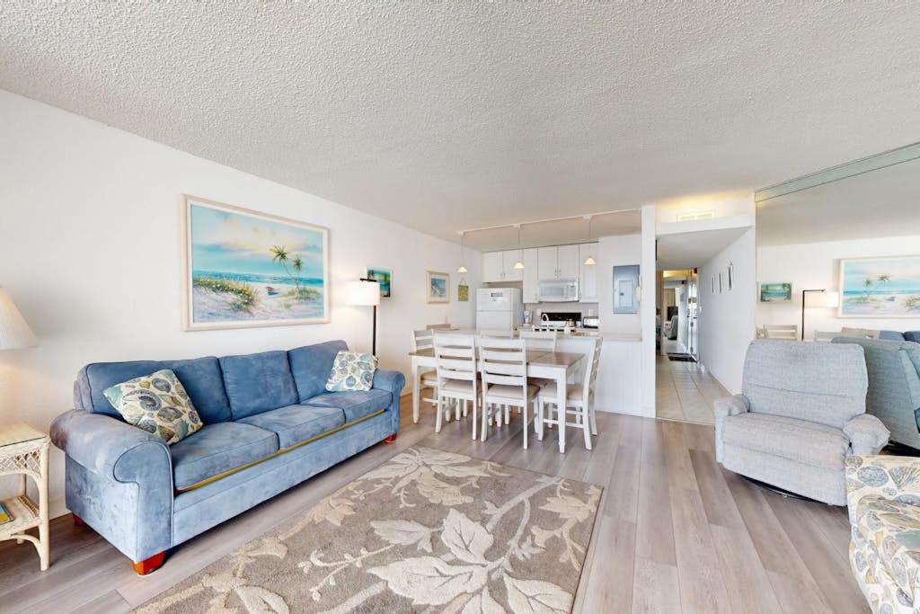 a living room with a blue couch and a dining room at Pyramid 6G in Ocean City