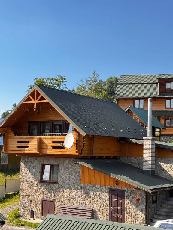 a house with a metal roof on top of it at Садиба Сузір'я in Vorokhta