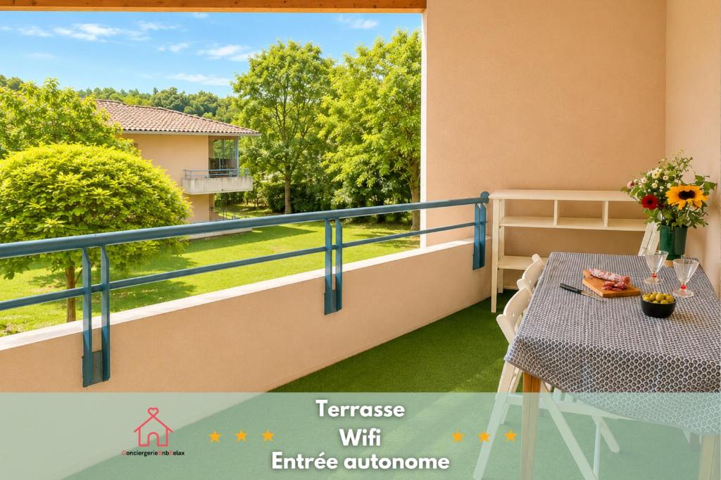 a balcony with a table and a view at " Balcon Nature " Terrasse - TV - Fibre in Muret