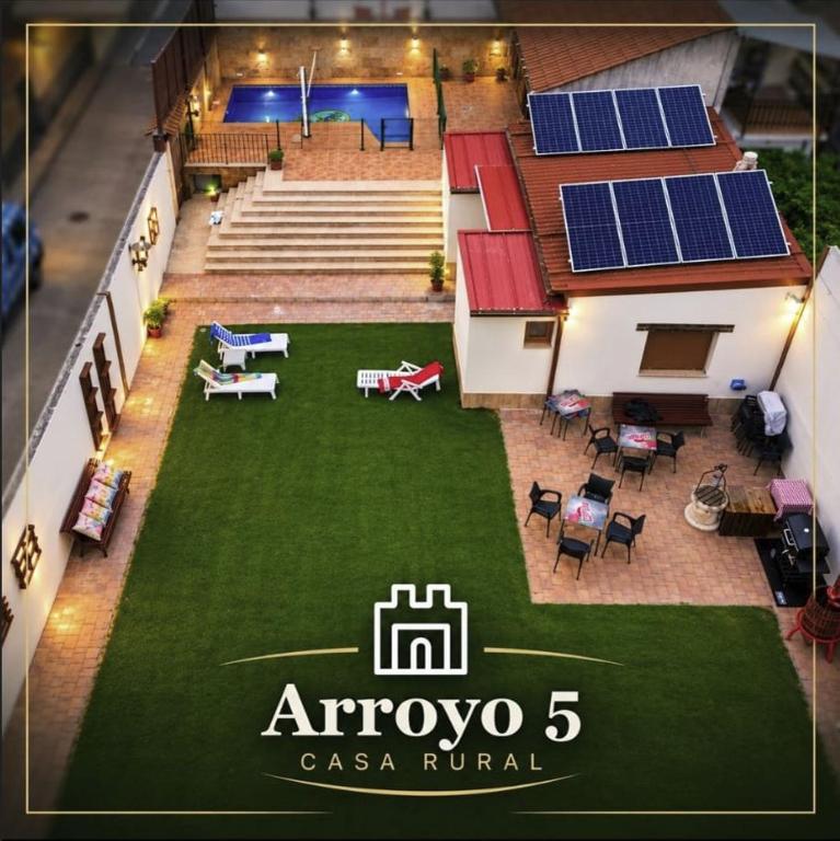 an image of a house with solar panels on the yard at Casa Rural Arroyo 5 in Mejorada