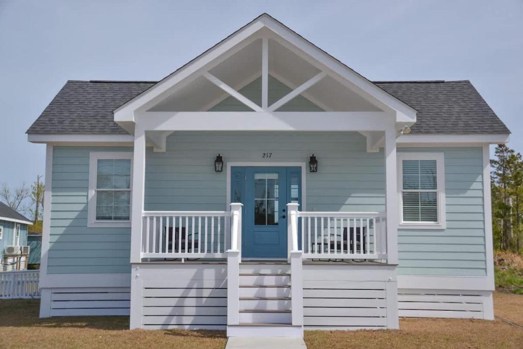 a house with a blue door and a porch at 2BR Cozy Cottage Private Dock in Davis