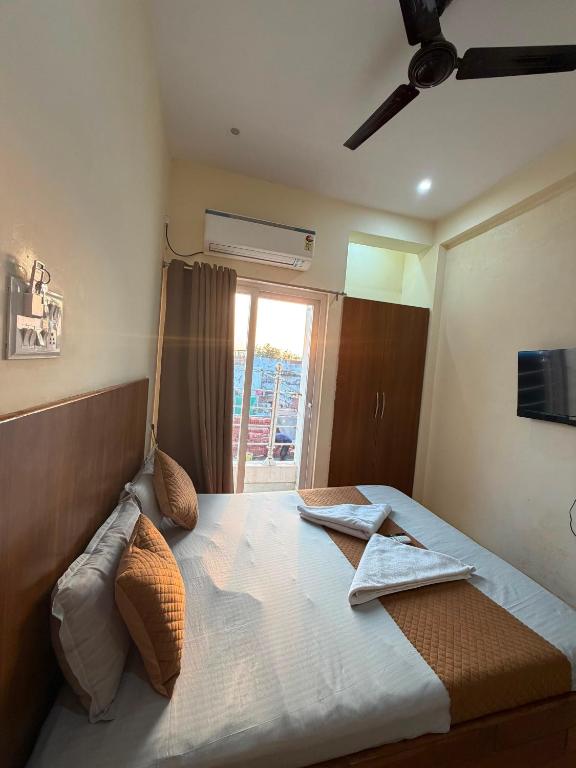 a bedroom with a large bed with a window at Kashi Vilas in Varanasi