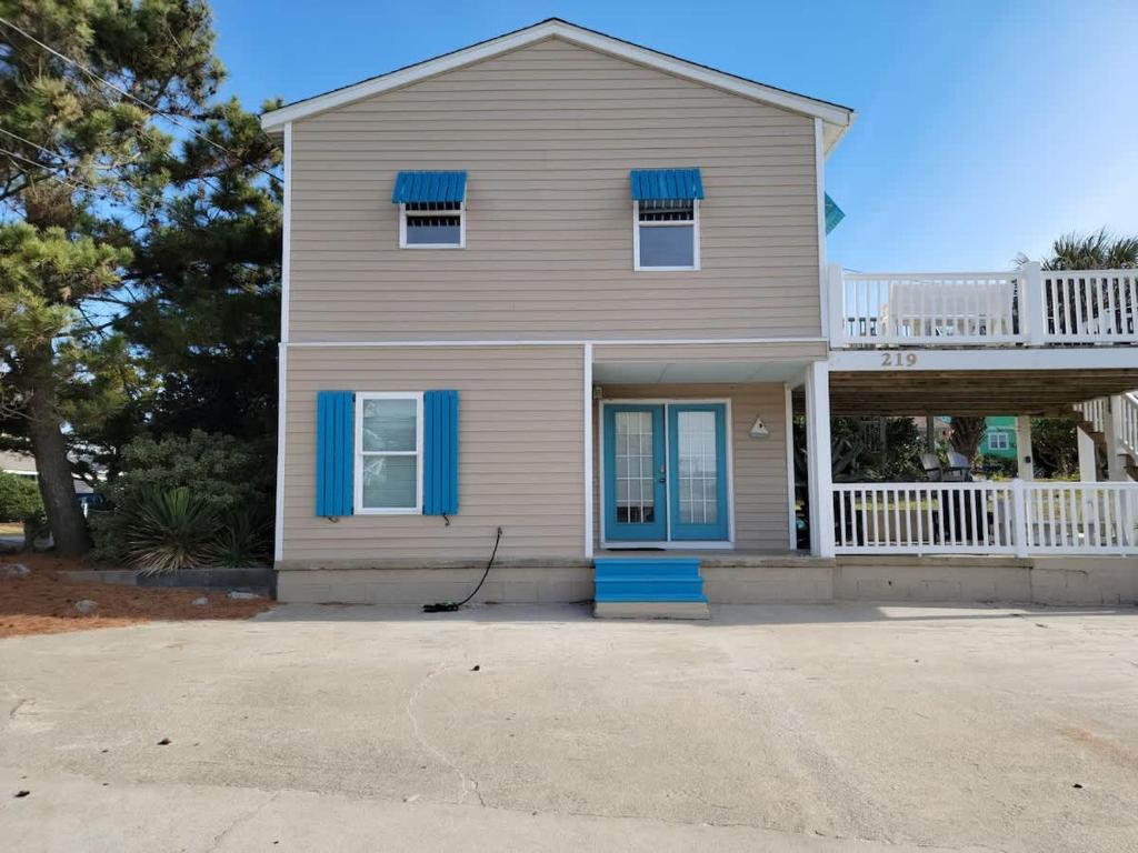 a gray house with blue shutters and a porch at Steps to Beach 2BR 2BA duplex in Atlantic Beach