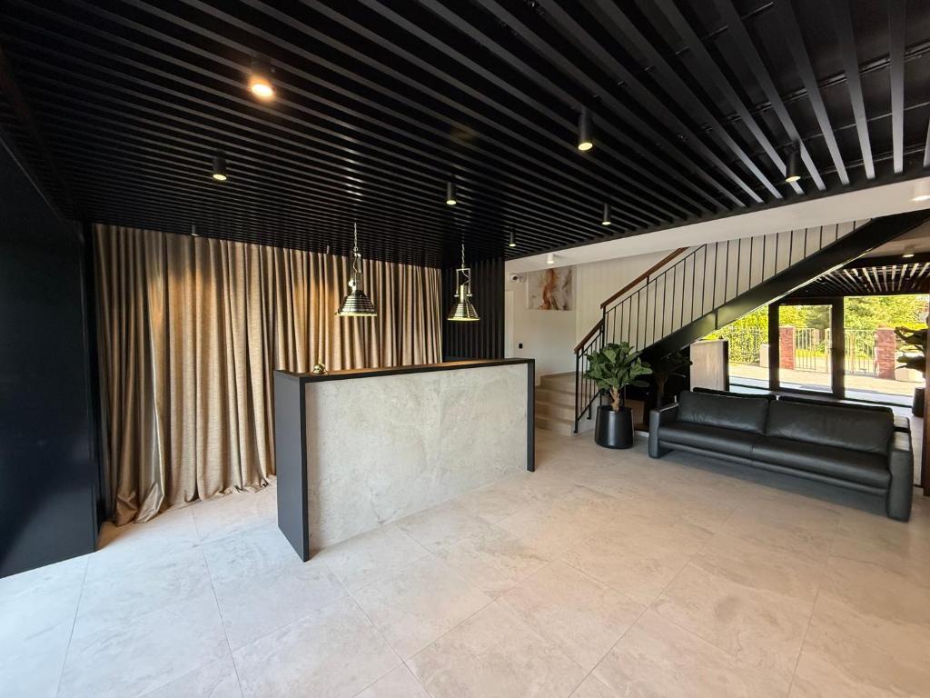 a large living room with a large screen in the middle at Koja in Rowy