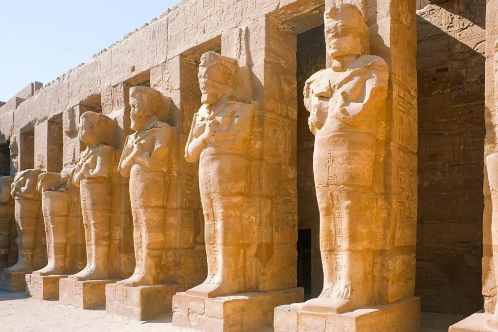 a row of statues on the side of a building at Vipxplor Travel in Luxor