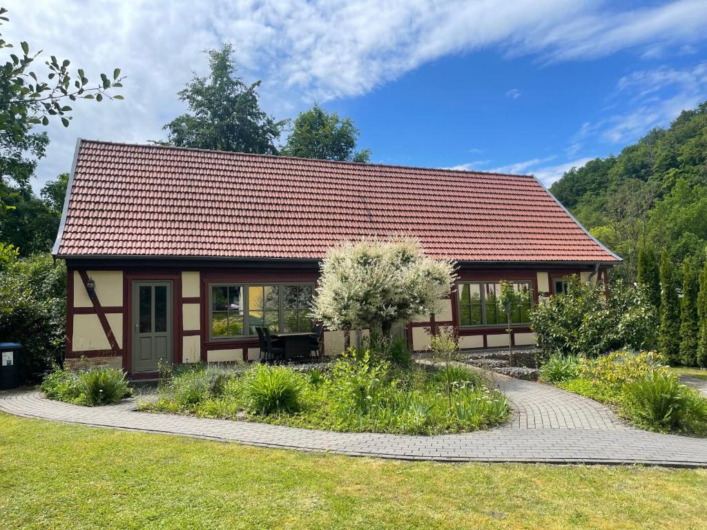 a small house with a red roof at Ferienhaus an der Thyragrotte in Stolberg