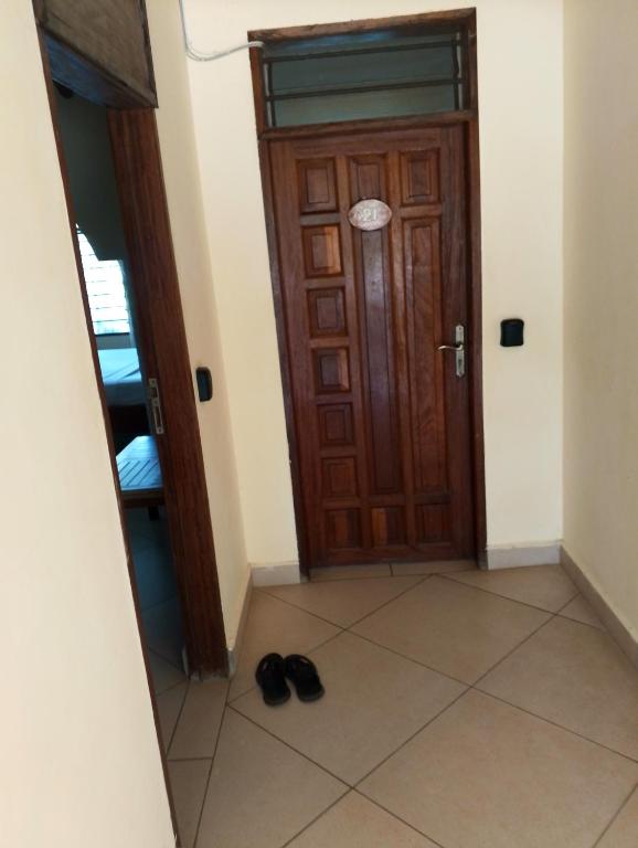 a pair of shoes sitting on the floor in front of a door at Beach front Spacious Studio in Malindi
