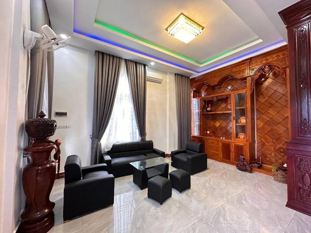 a living room with a couch and chairs and a table at Suman Thapa House in Kathmandu
