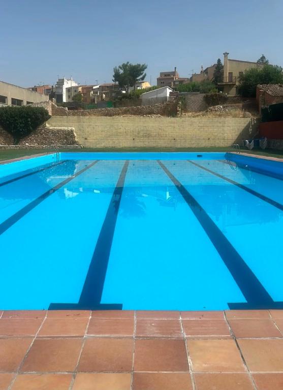 a large swimming pool with blue water at Ulldemolins Niuet in Ulldemolins