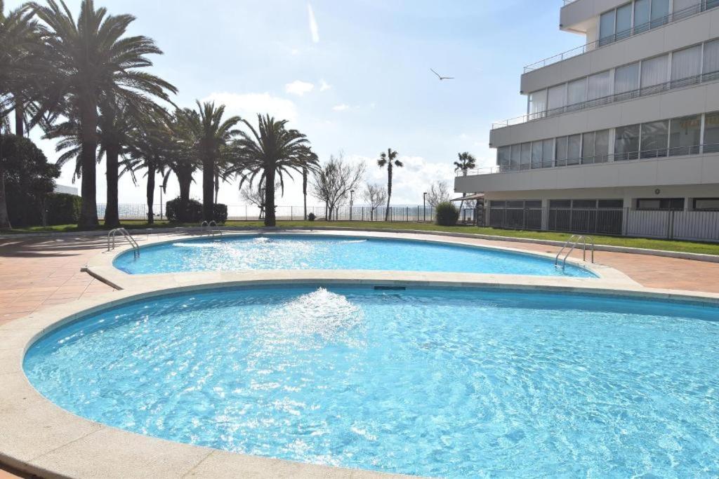 a large swimming pool in front of a building at Holiday 3401 in Roses