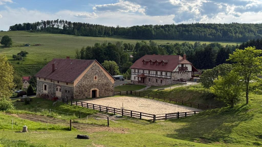 an aerial view of a large house with a barn at Agroturystyka Folwark Natura in Wleń