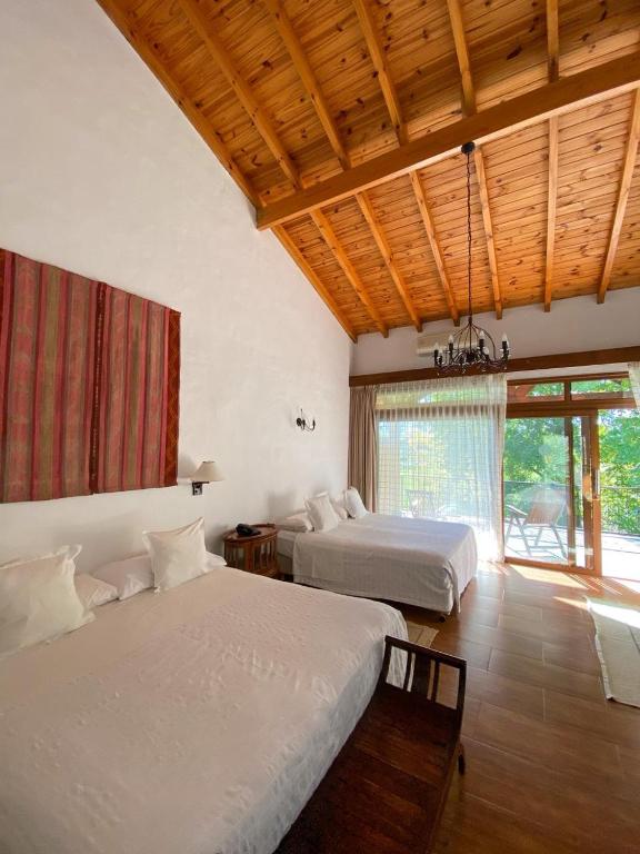 a bedroom with two beds and a large window at San Ceferino Hotel & Spa in Open Door