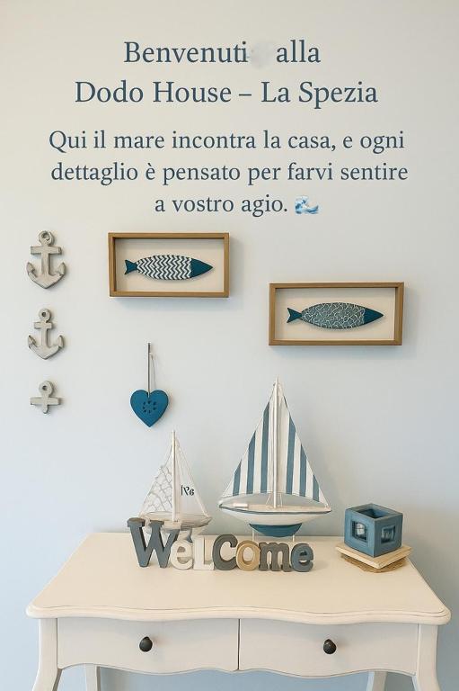 a room with a table with a shelf with a boat on it at Dodo House La Spezia in La Spezia