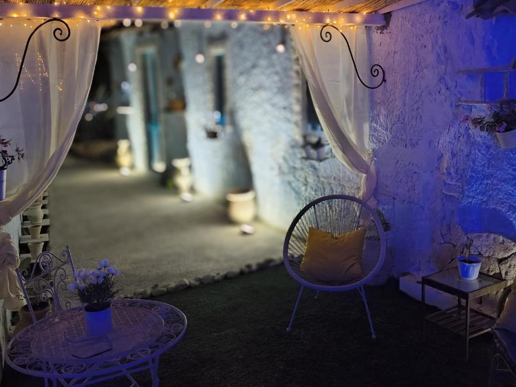 a room with a table and chairs and lights at THE KING'S LOFT Loft del Rè Sebi in Villasmundo