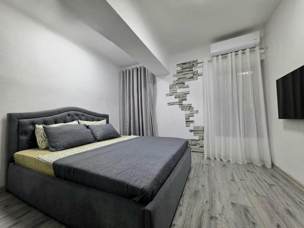 a bedroom with a king sized bed in a room at Sweet Home in Pogradec