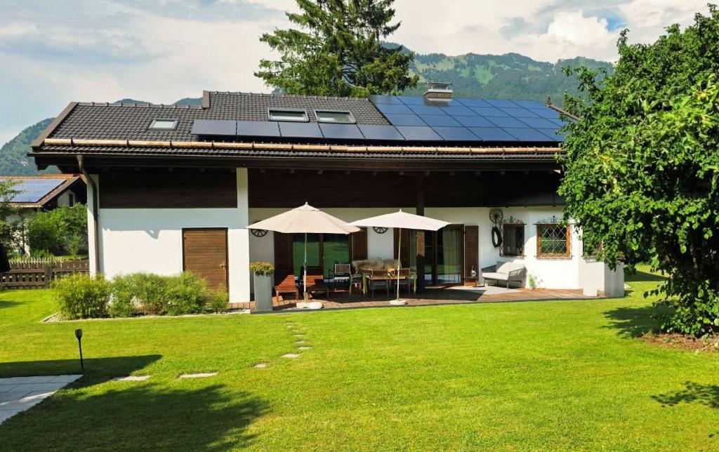 a house with solar panels on the roof at Chalet Anna in Unterwössen