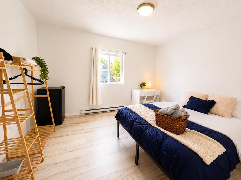a bedroom with a bed and a ladder at Màple room & Aurora House in Glace Bay