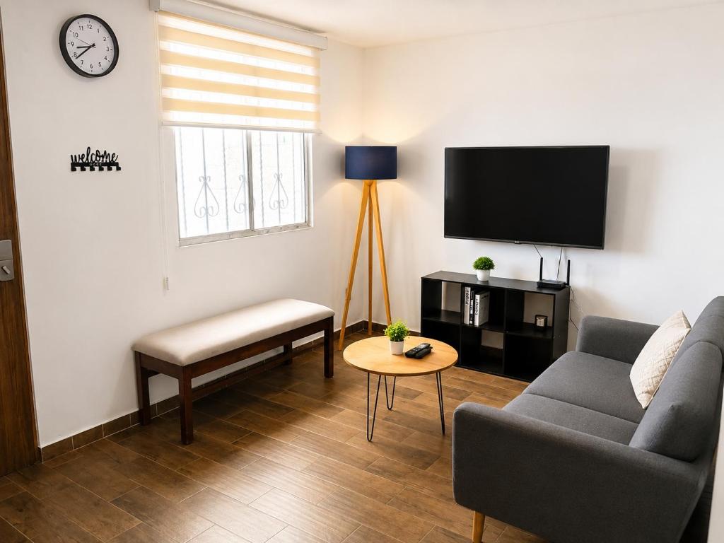 a living room with a couch and a tv at Casa Cholula in La Concepción