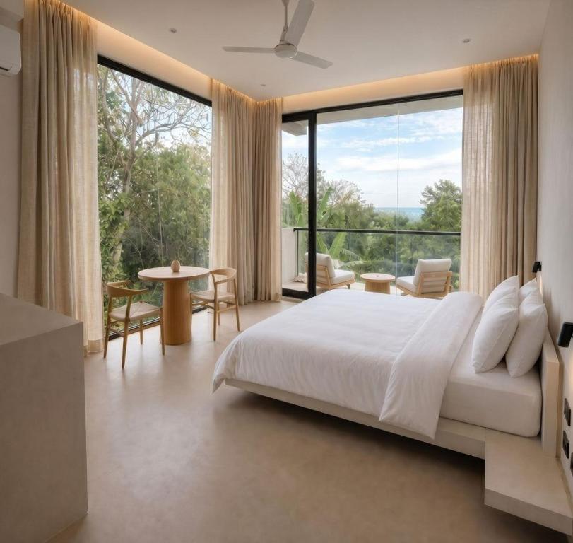 a bedroom with a large bed and a large window at Maxx Una in Unawatuna