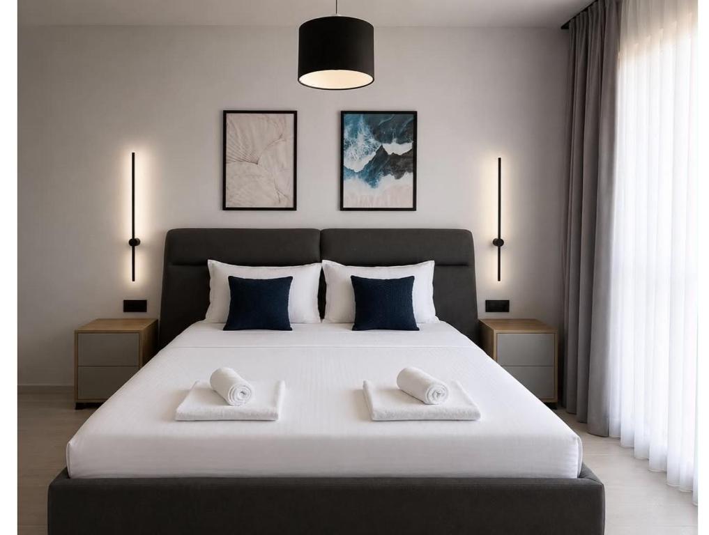 a bedroom with a large white bed with two pillows at Blue Breeze in Sinemorets