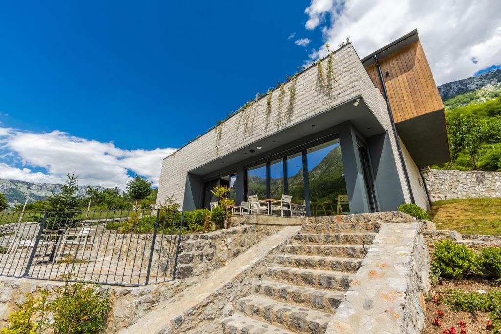 a house on a hill with stone steps at Odat n'Bogë - Breakfast Included by PikHost in Bogë
