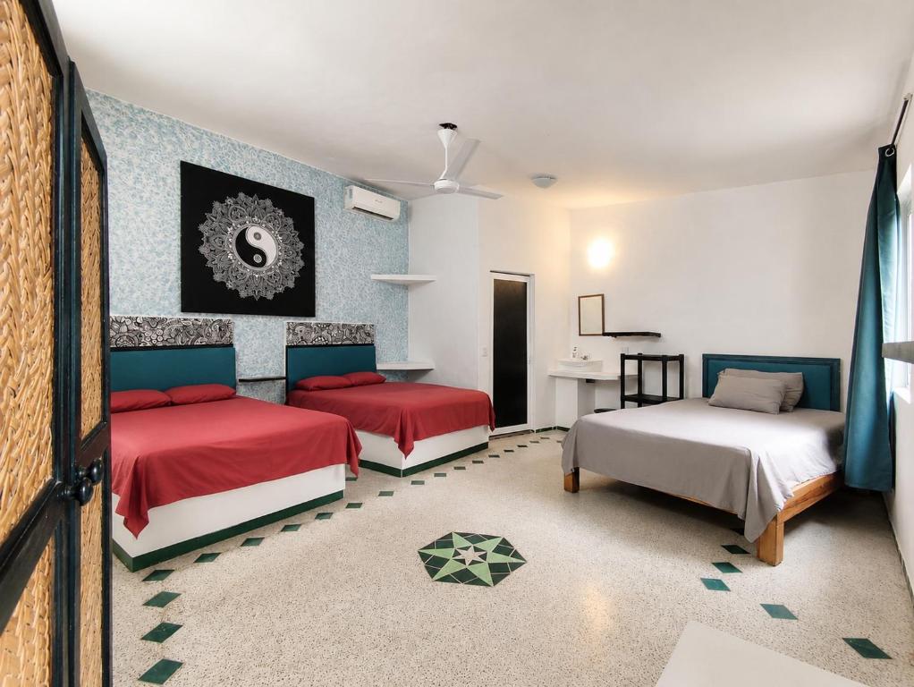 a bedroom with two beds and a desk in it at Casa ANTAHKARANA in Puerto Vallarta