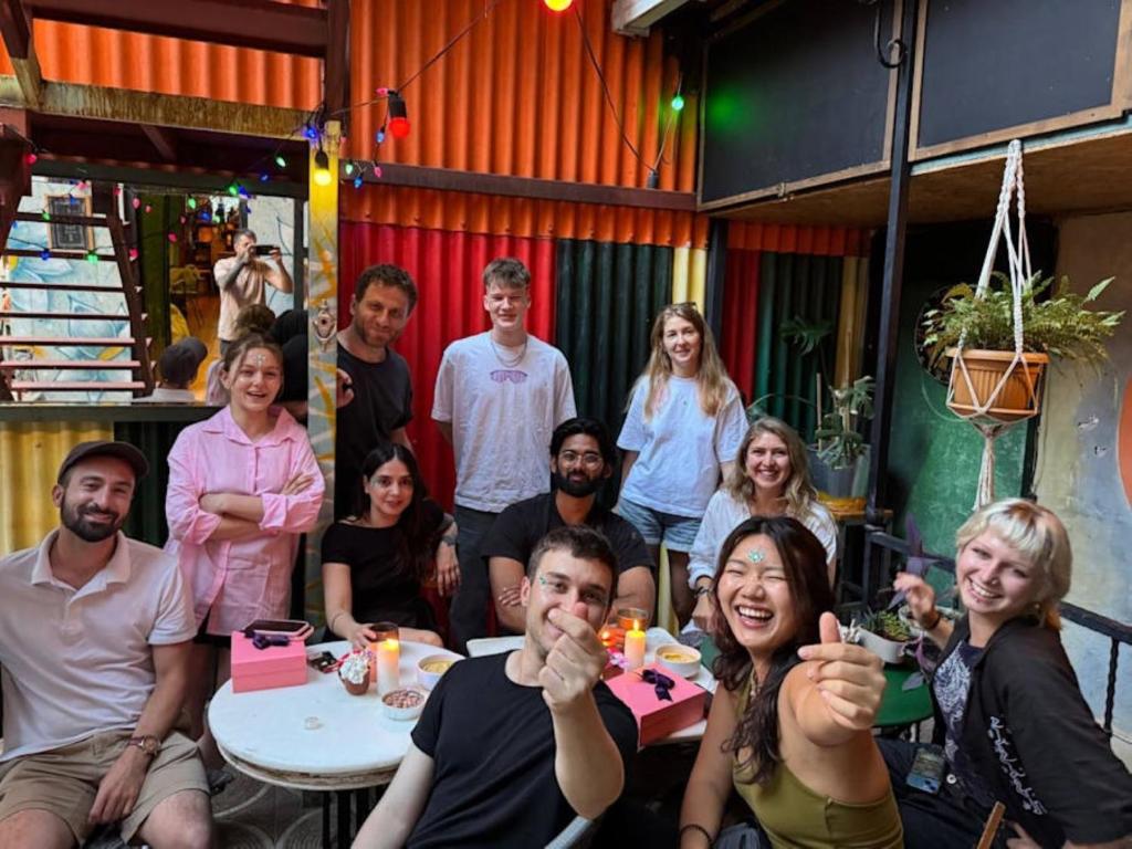 a group of people sitting around a table posing for a picture at YOLO Hostel in Istanbul