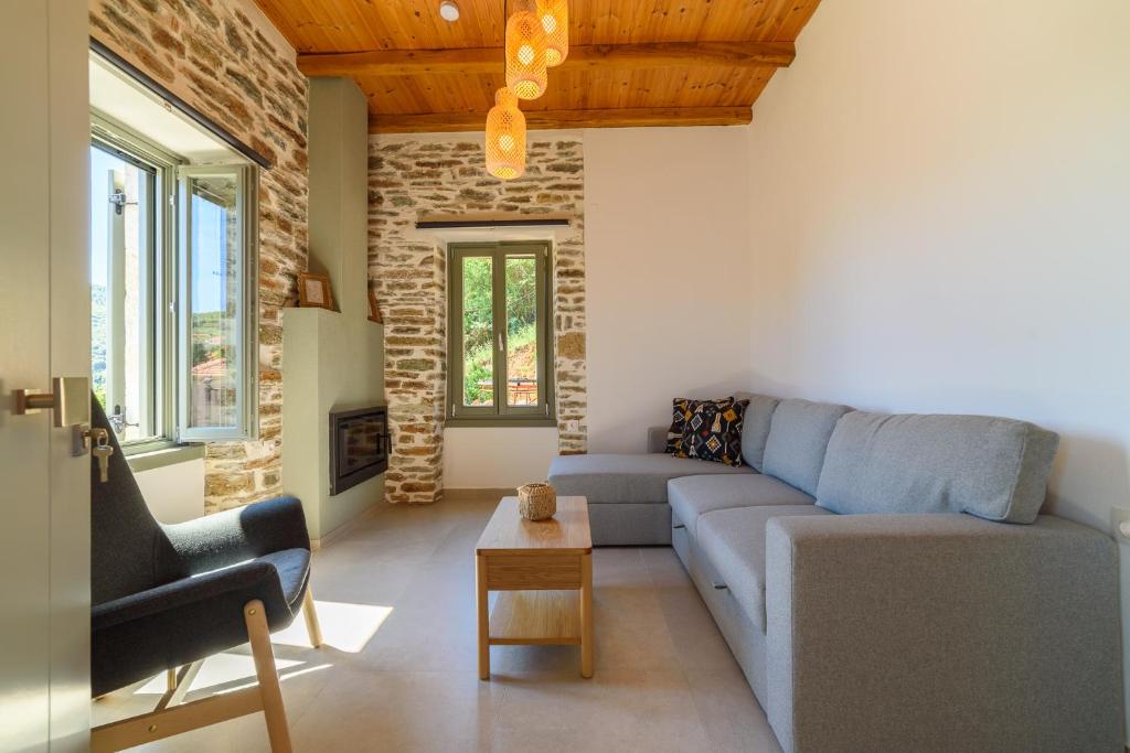 a living room with a blue couch and a chair at Orange House - Upper West apartment in Promírion