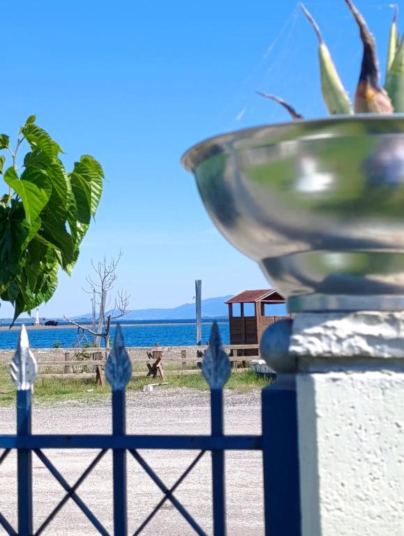 a bowl on a fence with the beach in the background at Silver SPOT Raches in Kouvéla