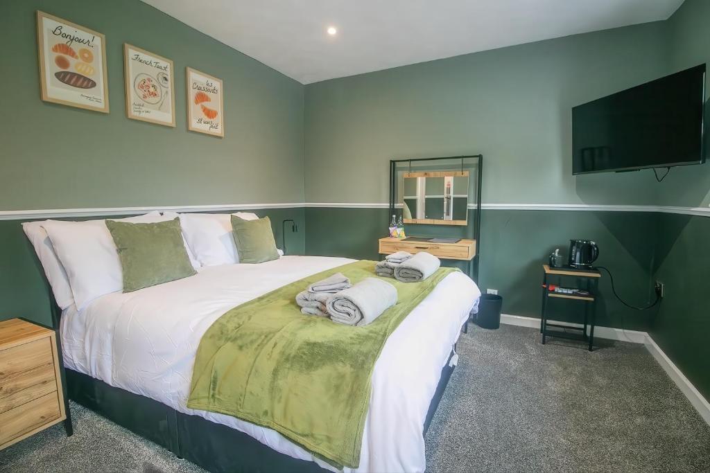 a bedroom with a bed with towels on it at Bronte Breaks in Haworth