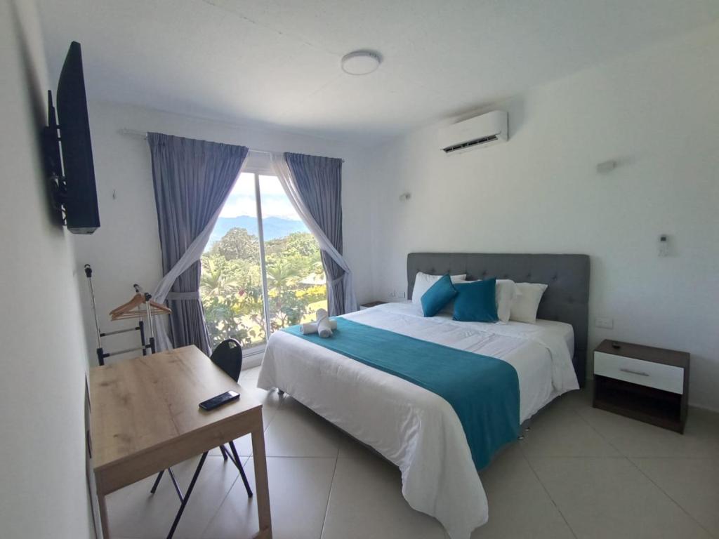 a bedroom with a large bed and a window at Hotel Santa Lucia in Socorro