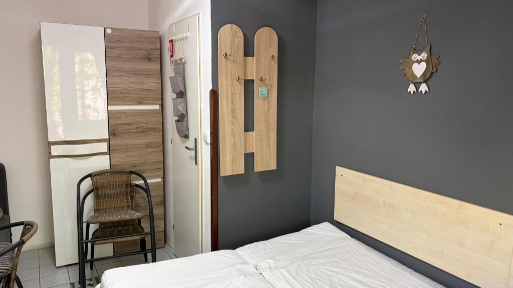 a bedroom with a bed and a chair in a room at Chata Zuzana in Bítov