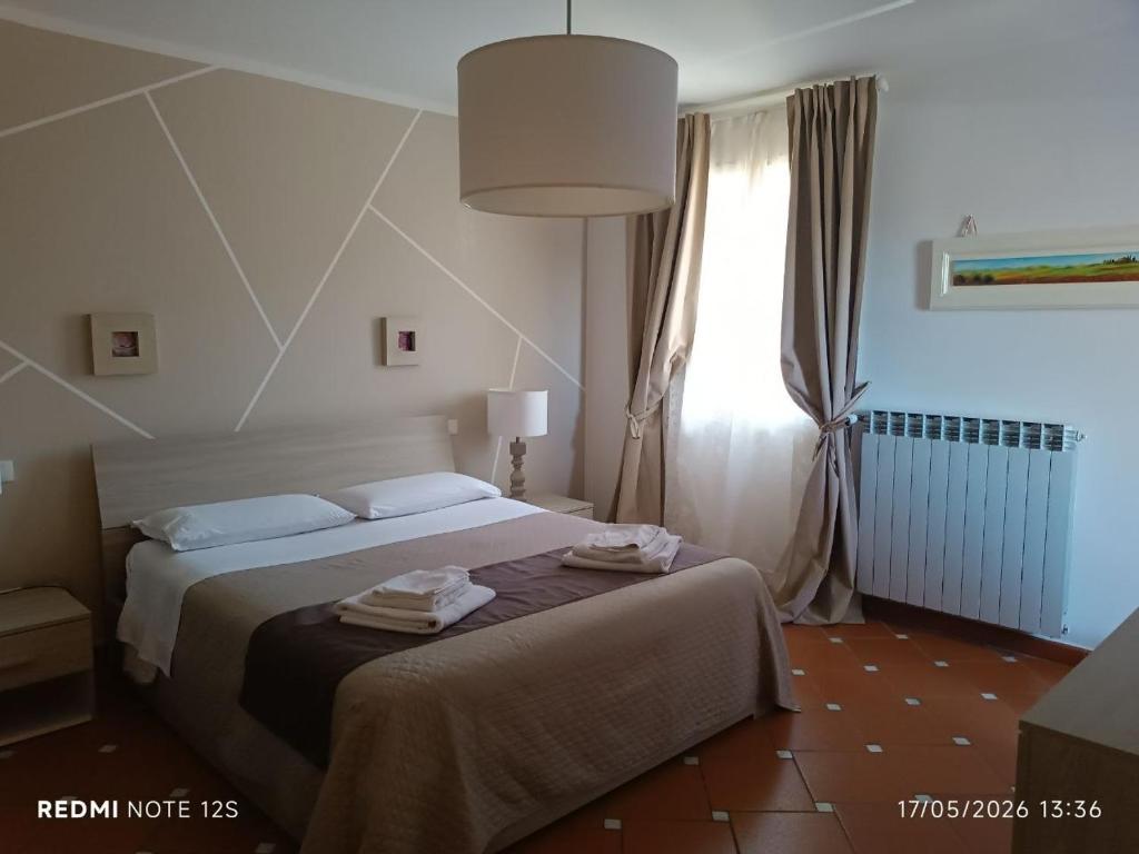 a bedroom with a bed with towels on it at La casetta del poggio in Poggio a Caiano