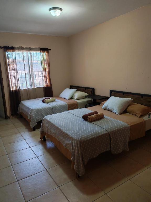 a hotel room with two beds and a window at D'Monte Alto 3 in Alto Boquete