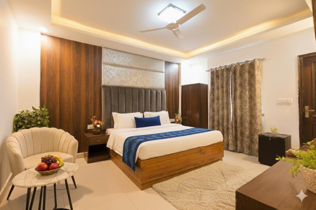 a hotel room with a bed and a chair at Hotel Marina Premium Near IGI Airport Delhi in New Delhi