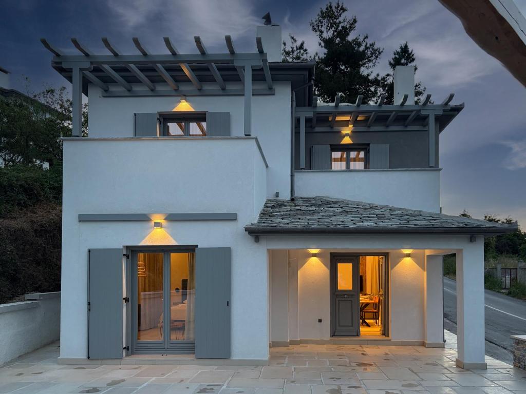 a white house with lights on top of it at Centaure Inn in Agios Dimitrios