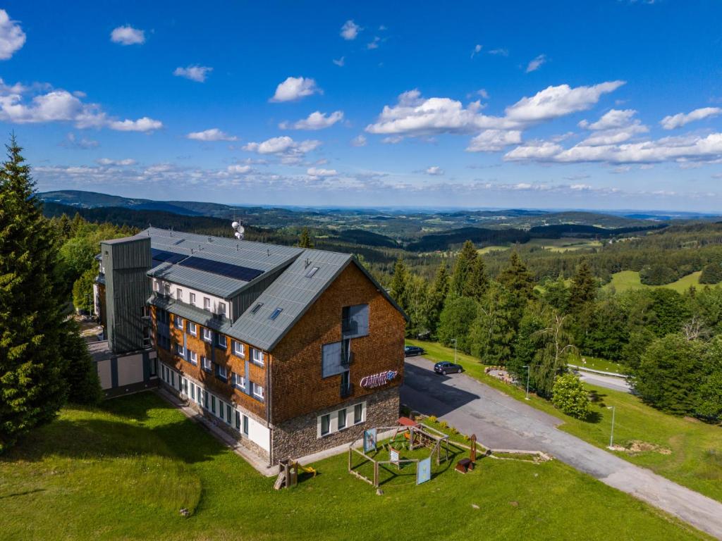 an aerial view of a building on a hill at Hotel Churáňov in Stachy