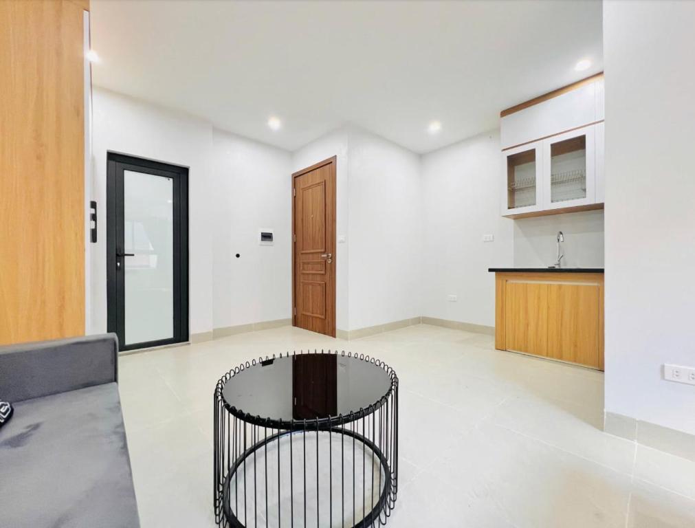 a living room with a black chair in the middle at Ahmed Rifan Hotel in Kulhudhuffushi