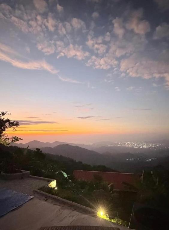 a view of the sunset from a building at REFUGIO el CAMPANO in Minca